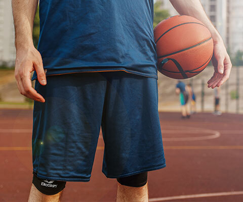 A man on a basketball court wearing compression shorts