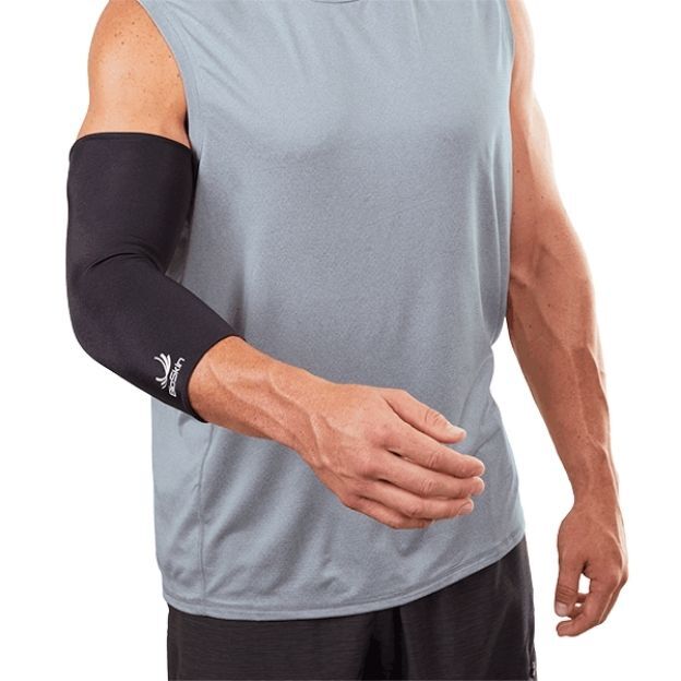 Man wearing a black BioSkin elbow compression sleeve providing support and flexibility.