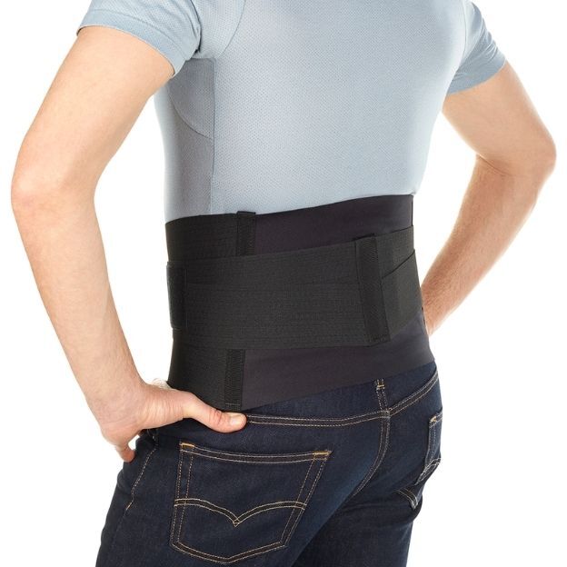 Man wearing a black BioSkin lower back brace providing lumbar support and compression.