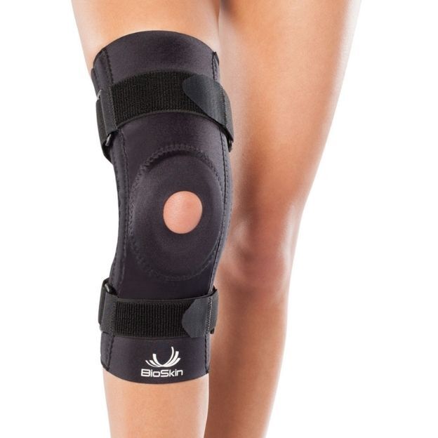 BioSkin patella stabilizer knee brace worn on a leg with adjustable straps and open kneecap support.